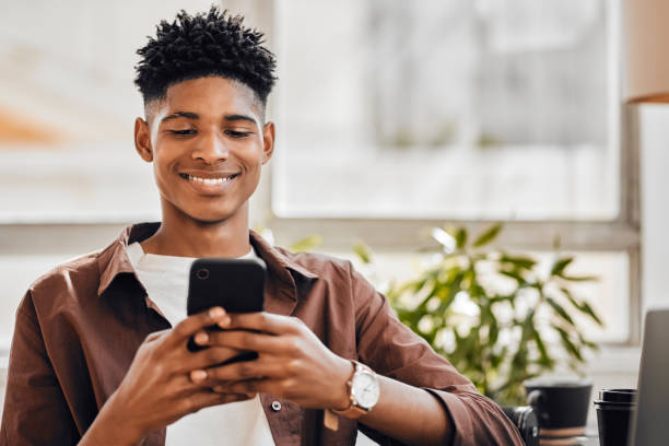 istock Relax, search or phone with black startup man for networking, contact communication or reading social media news. Designer or employee in Chicago for contact us, internet or smartphone app with smile 1434119030