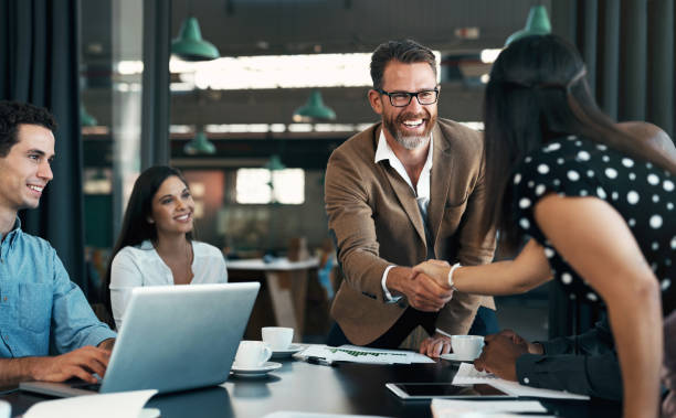Business people meeting and handshake for partnership, b2b contract deal or woman inclusion promotion. Corporate team, manager shaking hands in office for commitment, onboarding or client negotiation stock photo