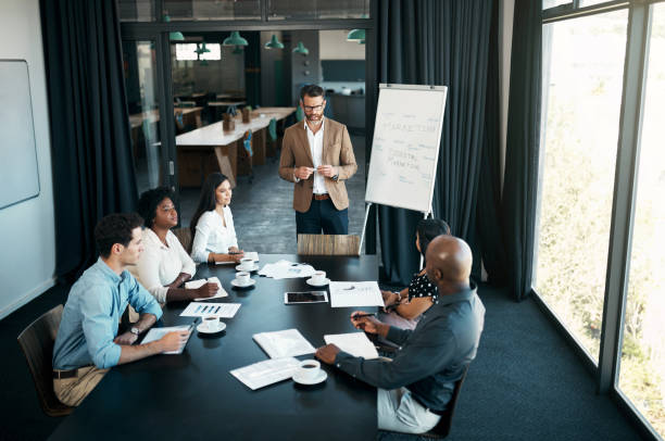 istock Meeting, presentation and training with a man CEO, manager or leader and his team in a workshop. Teamwork, leadership and growth with a male boss teaching his staff for mission, vision or development 1434119141
