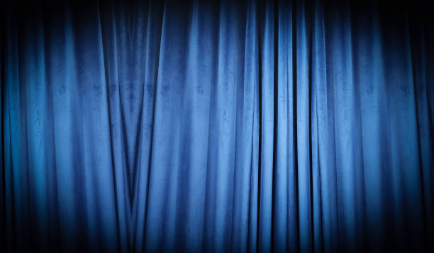 istock Blue curtain fabric making a dark banner background 1434119446