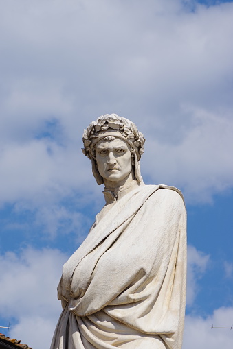 Florence, Italy, Tuscany. Close-up of the statue of Dante Alighieri installed in Piazza Santa Croce in front of the basilica of the same name. It was erected by Enrico Pazzi in 1865. It is a statue made of white Carrara marble.