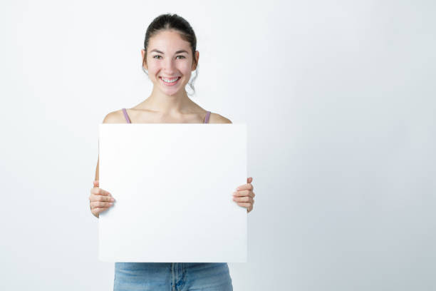 istock Young woman holding a blank billboard. 1434120074