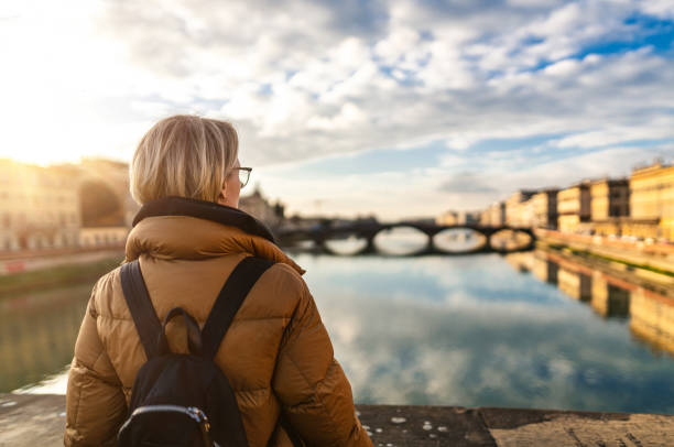 istock Tourist watching Arno river at sunset 1434120088