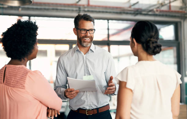 istock Businessman leadership, corporate training and planning, discussion and teamwork strategy management in startup. Happy manager, ceo and mentor conversation, coaching and collaboration with employees 1434120804