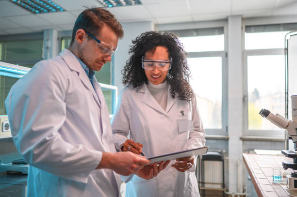 istock Multiracial Female and Caucasian Male Lab Workers at Work 1434121135