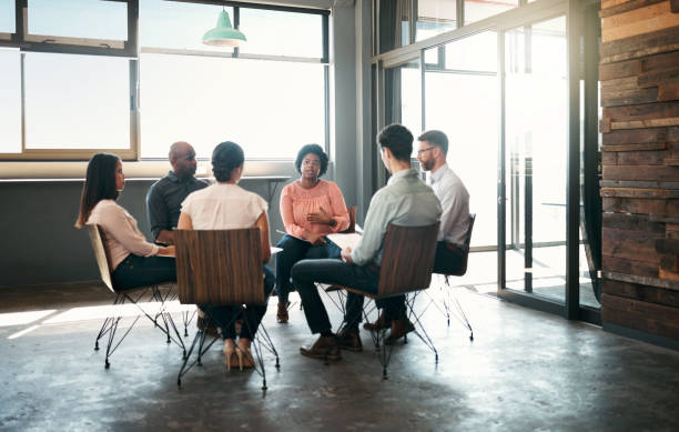 istock Business people, teamwork and collaboration support in therapy, team building or planning circle. Listen, diversity or office mental health group with men and women in work help community meeting 1434122483