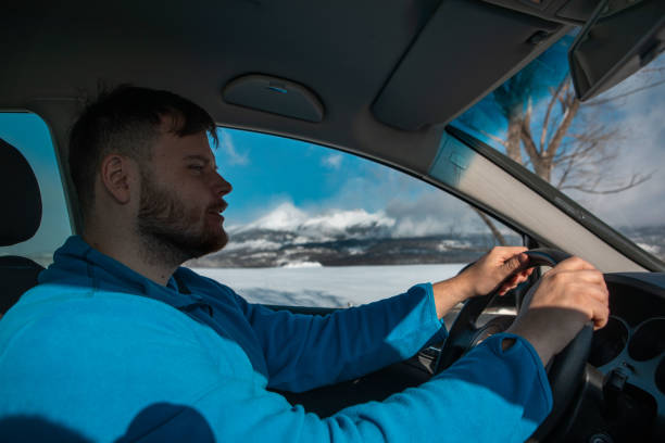 istock man hands on steering wheel winter road trip 1434124267