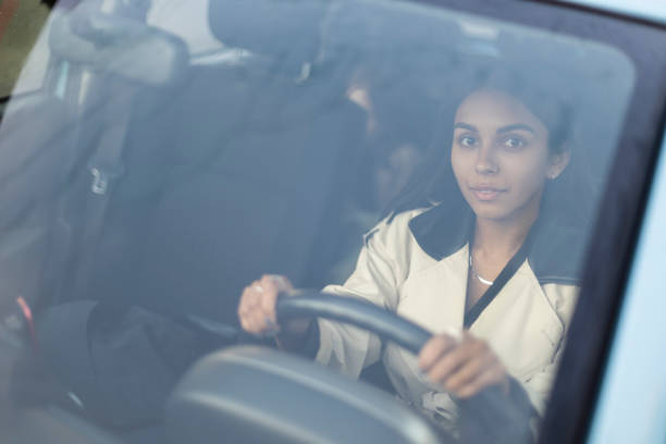 istock Confident and beautiful woman driving a car 1434124506
