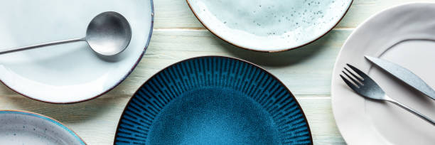 istock Modern tableware panorama with a blue plate and cutlery, shot from the top 1434126099