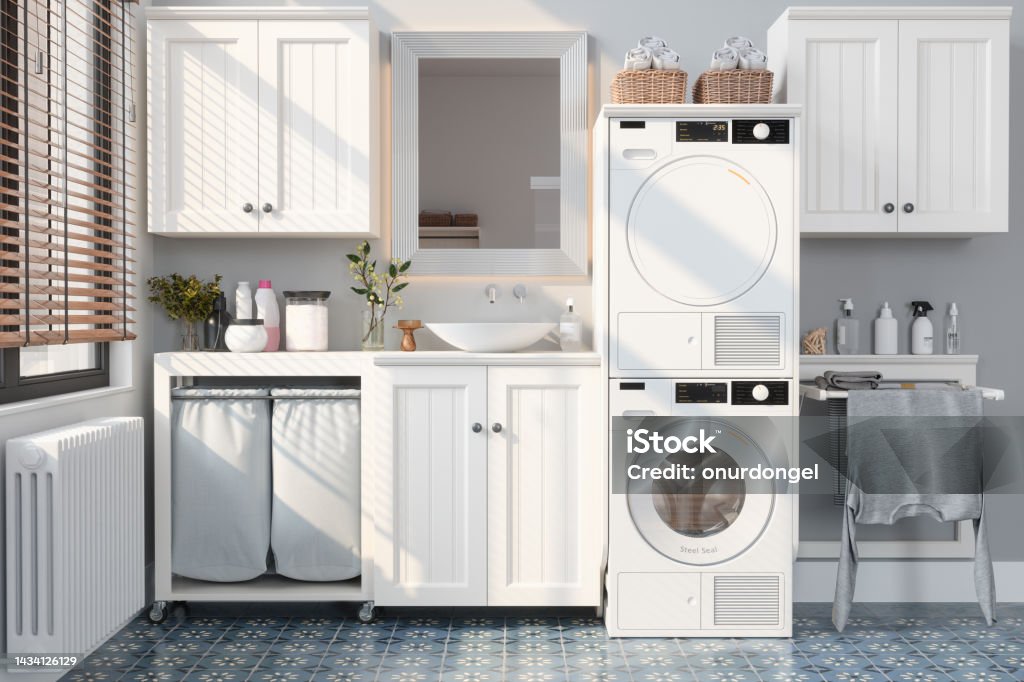 Modern Bathroom With Washing Machine, Dryer, White Cabinets and Drying Rack Utility Room Stock Photo
