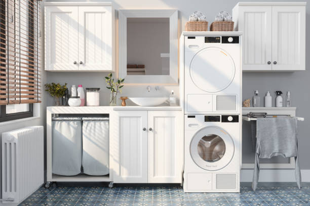 Modern Bathroom With Washing Machine, Dryer, White Cabinets and Drying Rack stock photo