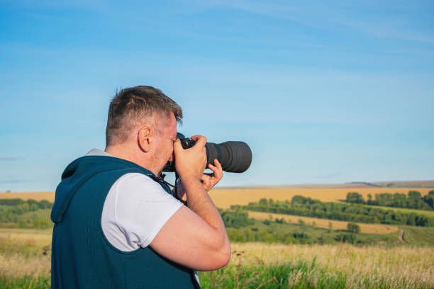 istock Photographer takes a rural landscape on camera 1434126198