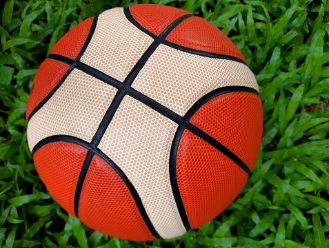 Closed up Basketball - green grass background.