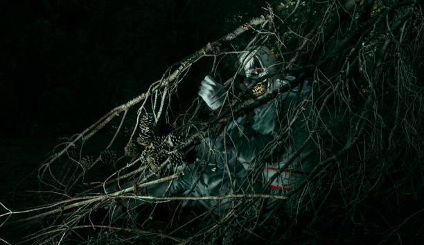 istock evil clown is hiding in the woods at night 1434129143