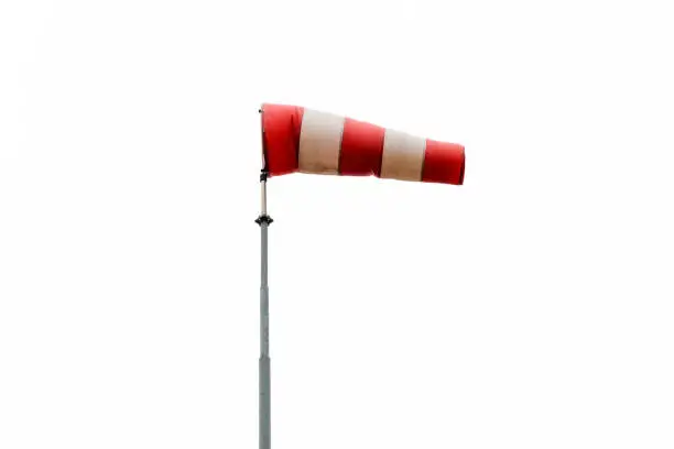 Red and white wind sign isolated on white. The windsock is used to warn traffic for strong winds at for instance bridges and show the direction of the wind at specific locations.