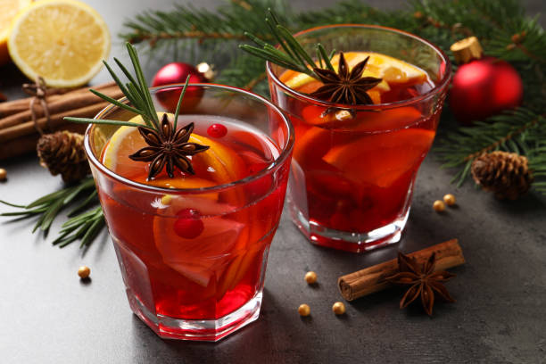 istock Delicious punch drink with cranberries, orange and spices on grey table 1434130839