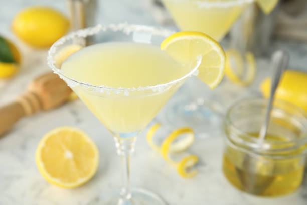 istock Delicious bee's knees cocktail and ingredients on white table, closeup 1434131323