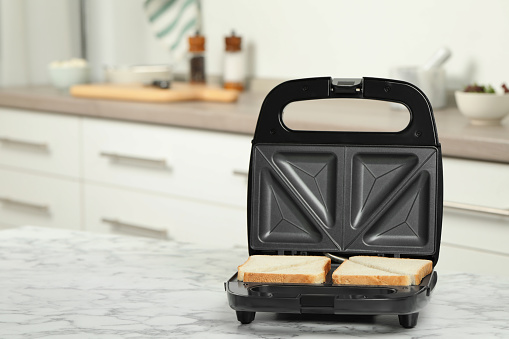 close up on single bread toast machine isolated on white background