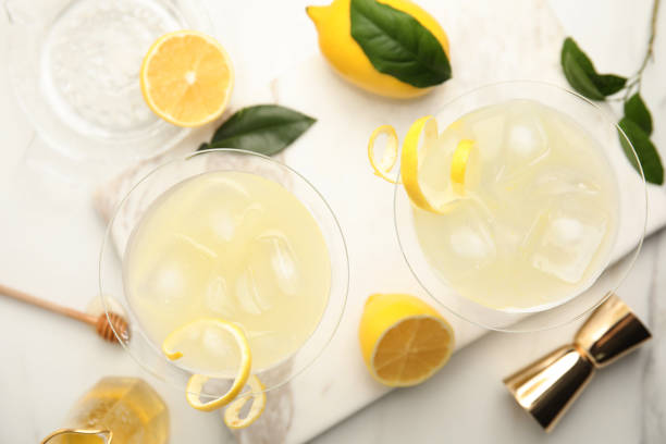 istock Delicious bee's knees cocktails and ingredients on white table, flat lay 1434131688