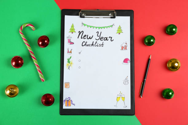 istock New Year Checklist. Flat lay composition with clipboard and festive decor on color background 1434132454