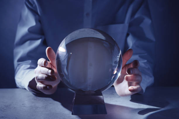 istock Businesswoman using crystal ball to predict future at table, closeup 1434132607