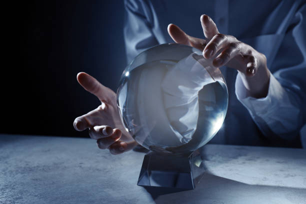 istock Businesswoman using crystal ball to predict future at table, closeup 1434132620