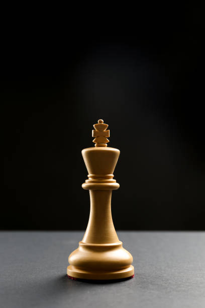 istock Wooden king on table against dark background, space for text. Chess piece 1434133040