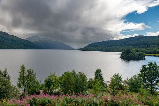 The still waters of Loch Lomond on a summers day in Scotland, UK.