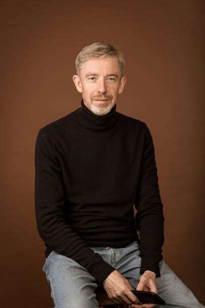 istock Studio portrait of white 50 year old man with beard on brown background 1434133068