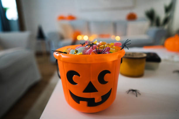 Bucket in a pumpkin shape, full with candy stock photo