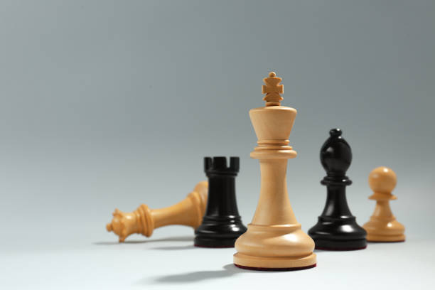 istock Different chess pieces against light background, focus on white king. Space for text 1434133276