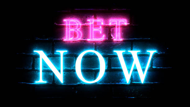 istock Bet Now glowing neon inscription on brick wall background. 1434133400