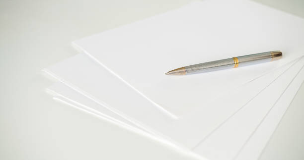 istock A pen on clean white blank sheets of paper 1434134702