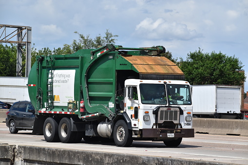 Garbage truck shares the highway on Gulf Freeway, Interstate 45 (1-45) in Houston, Tx