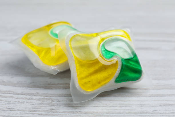 istock Dishwasher detergent pods on white wooden table, closeup 1434135313