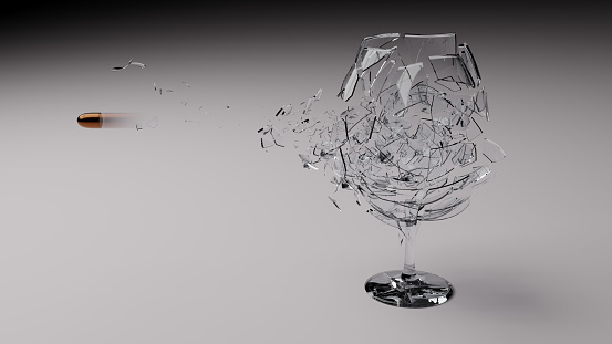 Bullet shot through a wine glass and shattering it