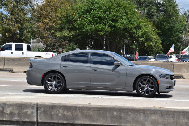 Dodge Charger Grey Dodge Charger cruising on I-45 in Houston, Texas 2022 dodge charger stock pictures, royalty-free photos & images
