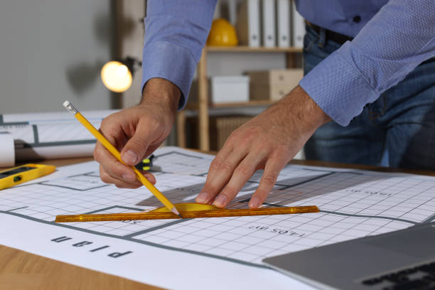istock Architect working with construction drawings in office, closeup 1434137878
