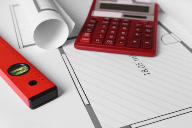istock Construction drawings, calculator and ruler, closeup view 1434138873
