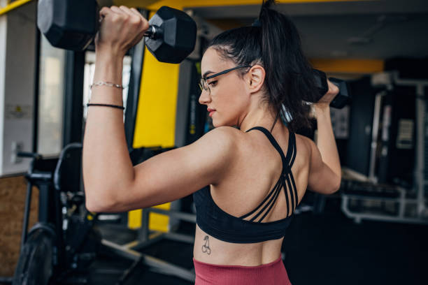 istock Young woman training with dumbbells 1434141285