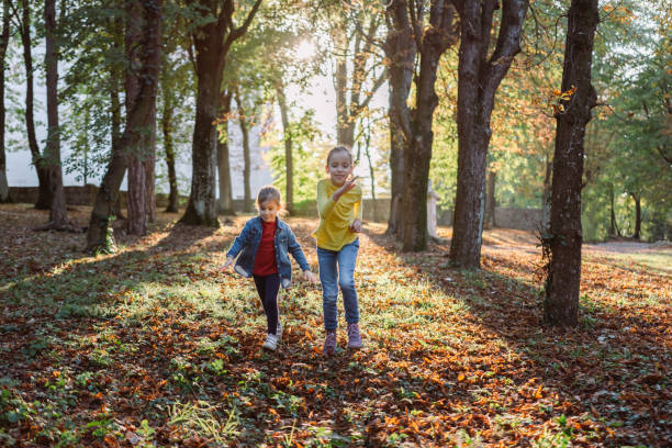 istock Girls running in autumn park 1434141835