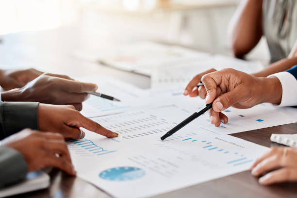 istock Marketing, analytics and business meeting with documents, chart and paper for planning in corporate company. Innovation, data and strategy with business people in growth, idea and goals conference 1434141913