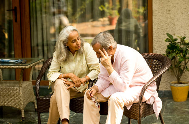 Senior woman comforting husband suffering with depression