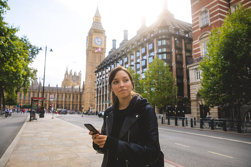 Woman in the city of London using smartphone