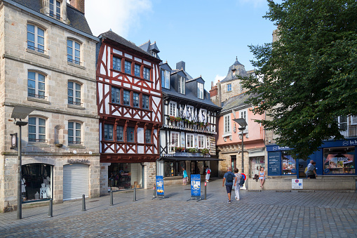 Quimper, France - July 24 2022: Half-timbered town houses located Place Saint-Corentin.