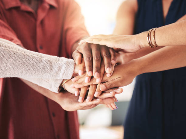 istock Hands, trust and team building workshop for support of inclusive corporate company workplace. Solidarity, collaboration and cooperation in diverse business workforce with multiracial staff. 1434146123