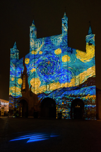 Alba, Italy  November 21, 2021  Light mapping over the Saint Lawrence cathedral of Alba (Piedmont, Italy) with artistic paintings projected over the facade on november 2, 2021