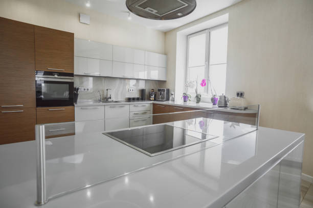 Modern Home Interior. Kitchen with Sink and Black Oven. White Furniture. LED Light. Luxury Home.