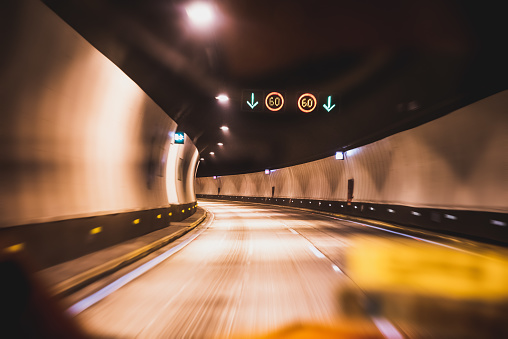 Defocused background of highway road tunnel with yellowish atmosphere - Urban transportation concept on warm contrast filter