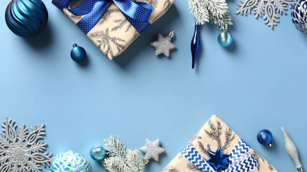 istock Christmas frame. Flat lay gift boxes, snowflakes, blue baubles, silver decorations on pastel blue background. Elegant Xmas card design, New Year banner mockup. 1434154865